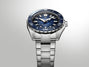 Stainless steel dive watch with dark blue dial, white hour markers, and matching blue rotating bezel on metal bracelet.