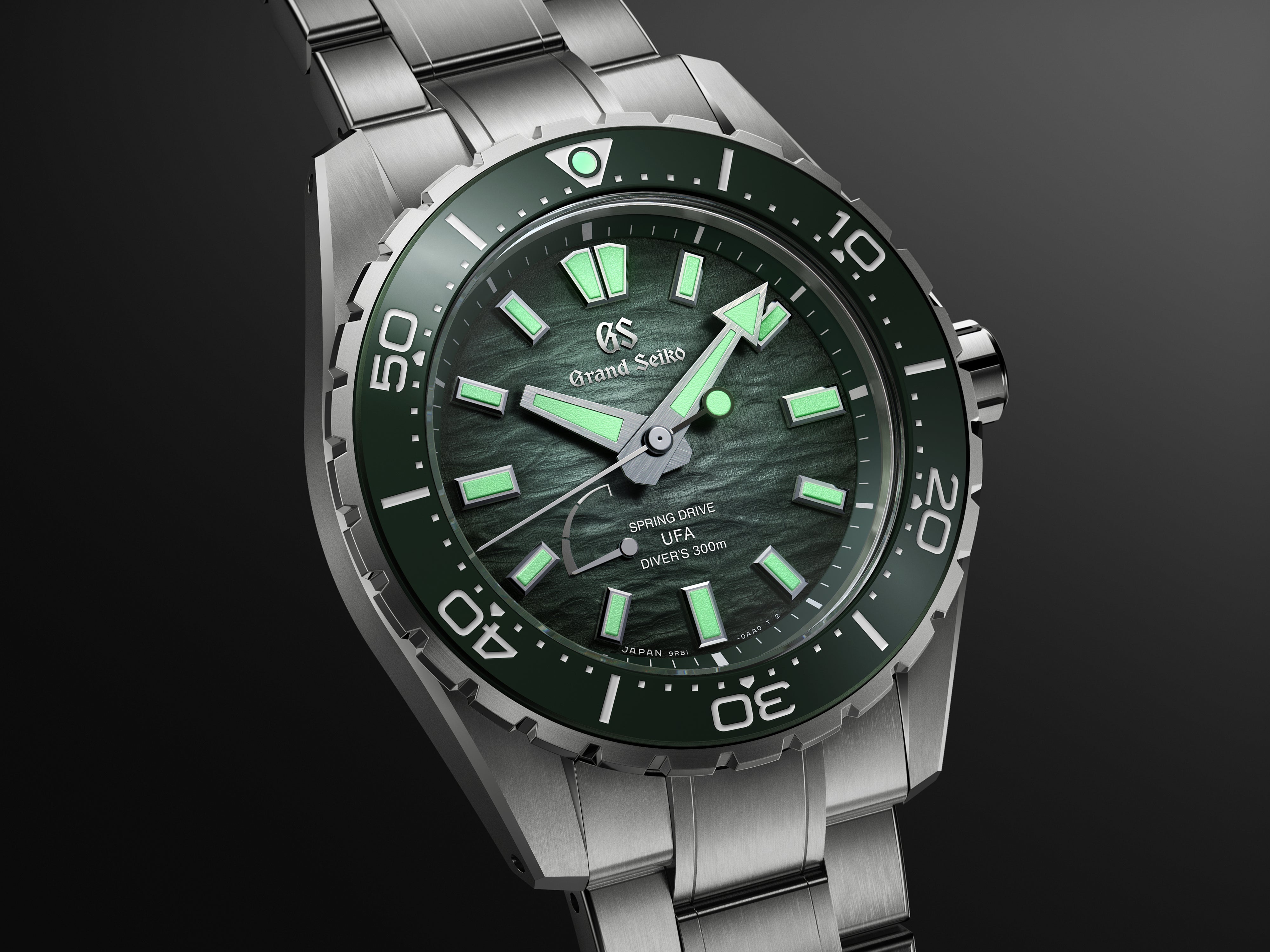 Stainless steel diver watch with dark green dial, luminous hour markers and hands, unidirectional bezel, and three-link brace