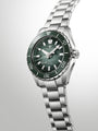 Grand Seiko Spring Drive diver watch with green sunburst dial, stainless steel case and bracelet, rotating bezel marked to 70