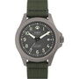 The Timex Expedition Titanium Automatic features a textured dark gray dial with white numerals and hands, date at 3 o’clock, titanium case (200M/660FT water-resistant, shock resistant), and a green fabric strap.