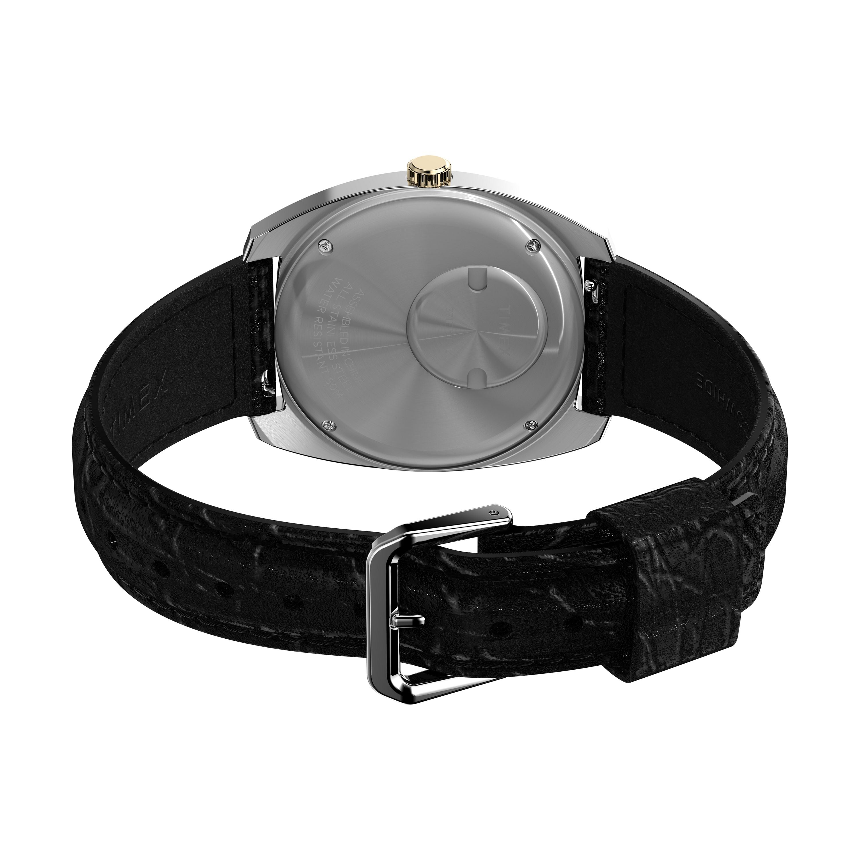 A close-up of the Q 1978 Day/Date by Timex showcases its polished silver case, gold crown, and textured black leather strap with a silver buckle, highlighting the refined details and classic quartz movement.