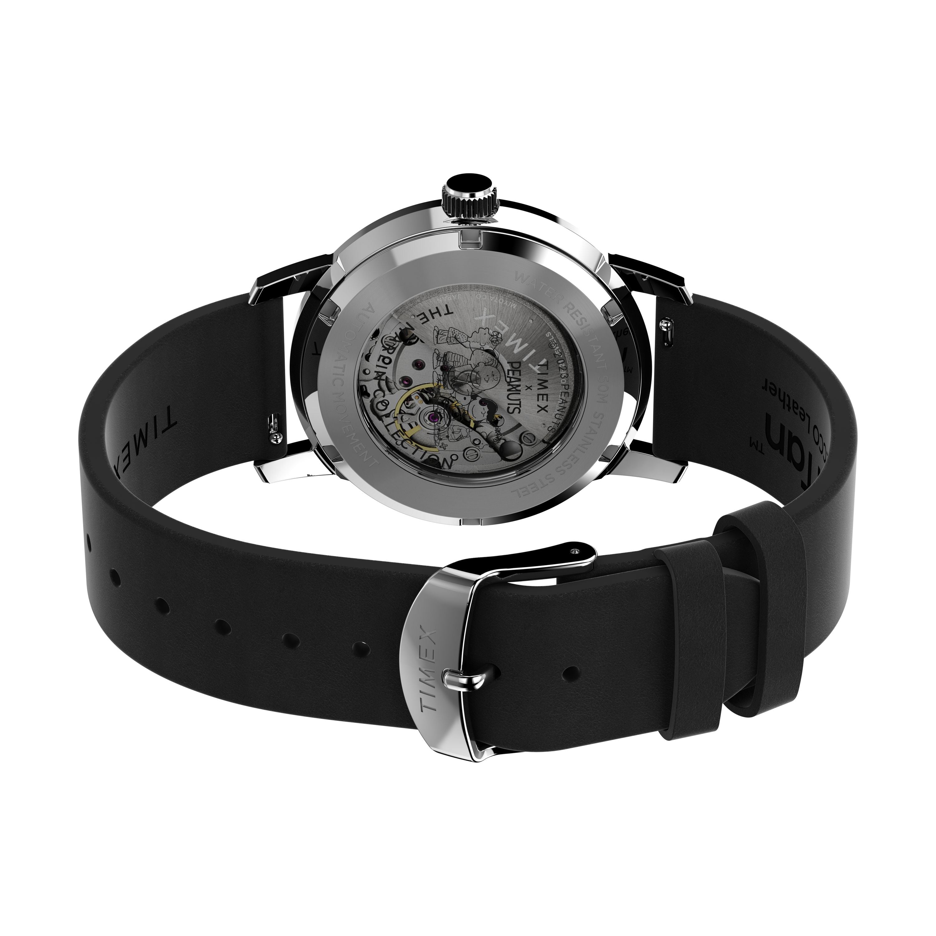 A close-up of the Timex G SS AU PEANUTS SNOOPY FLYN ACE 25 wristwatch, featuring a black silicone strap and an exposed mechanical movement visible through its transparent case back.