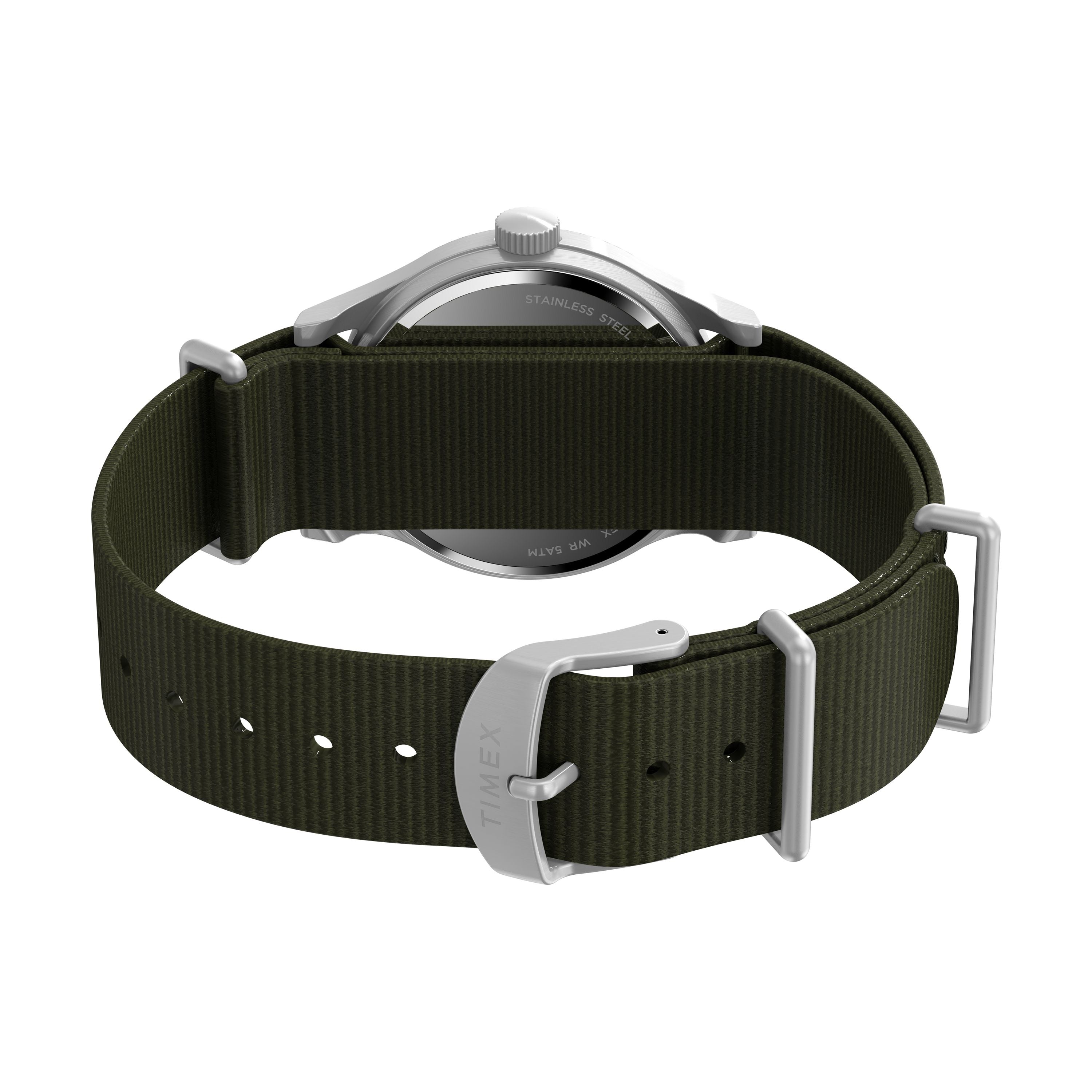 A close-up of the G SS MW SW MK1 36 BLK DL GRN STP 25 shows its military style with an olive green recycled fabric strap, a silver case, and a buckle engraved with the Timex brand.