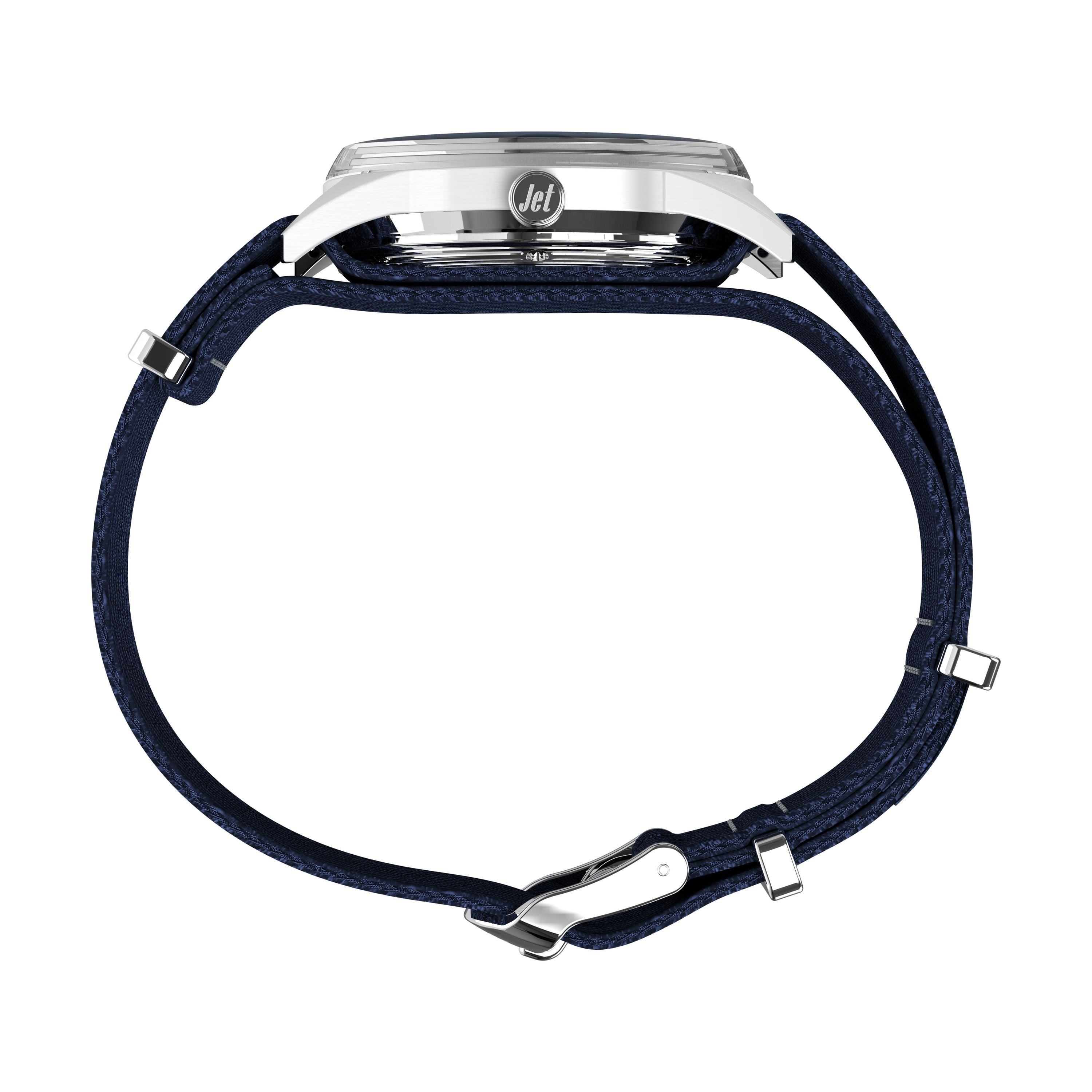 Side view of the Timex Marlin® Jet Automatic, featuring a silver case labeled "Jet," a dark blue fabric strap laid flat and unclasped, showcasing its retro-futuristic design and domed Hesalite crystal.