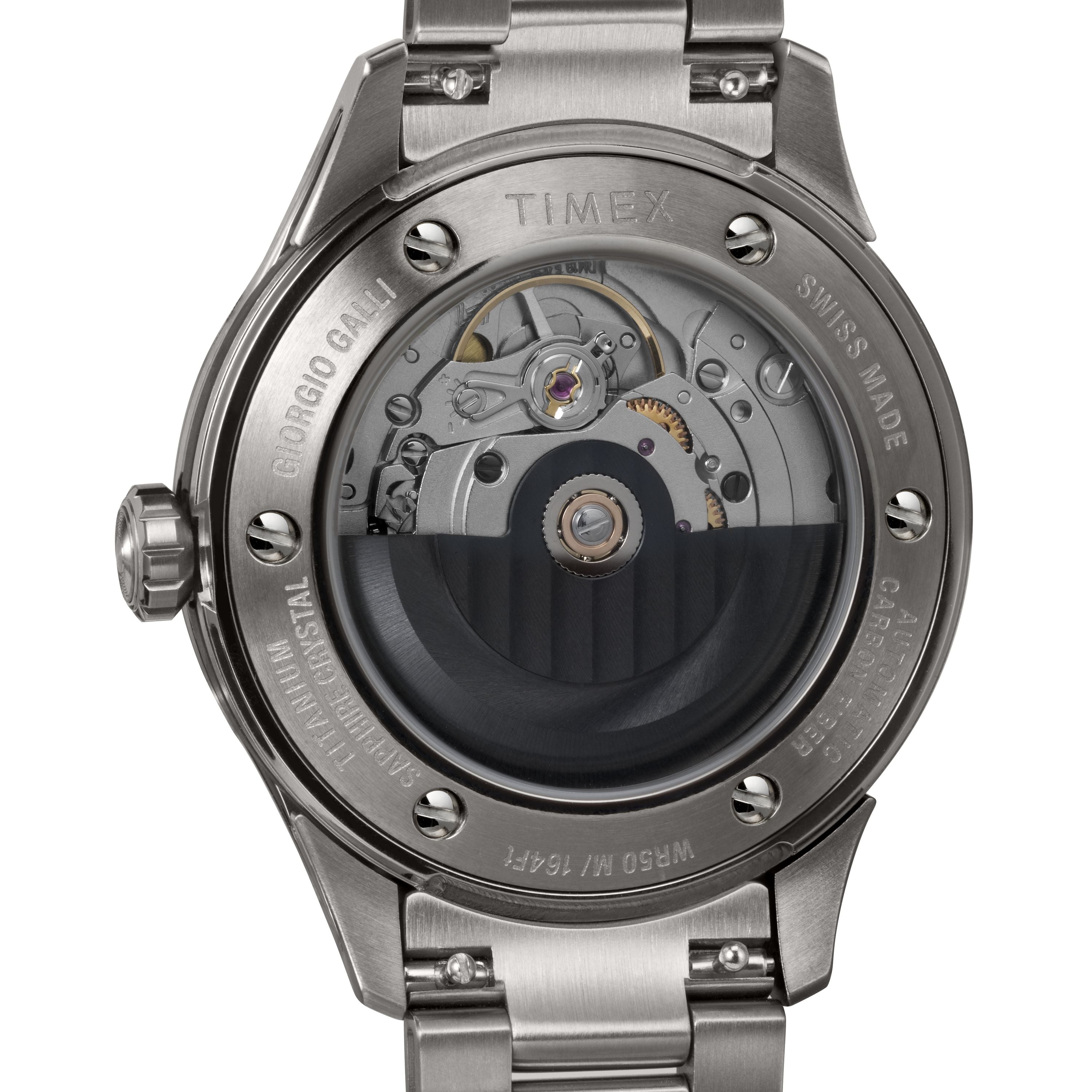 Close-up of the back of a Timex Giorgio Galli S2Ti Automatic 38mm watch, showcasing its intricate mechanical movement through a sapphire crystal case back, with visible gears and engraved markings on the stainless steel casing.