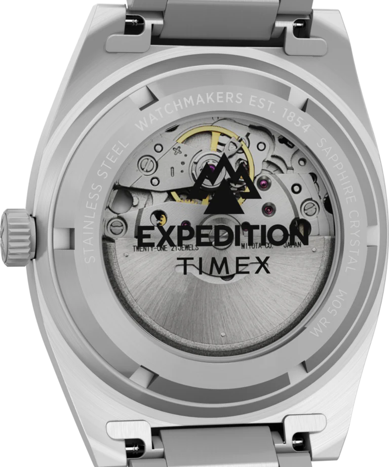 Close-up of the back of the Timex G SS AU BW CAPSTONE 39 BLK DL 25, showing its exposed mechanical movement through a transparent case back with engraved text on the stainless-steel edge.