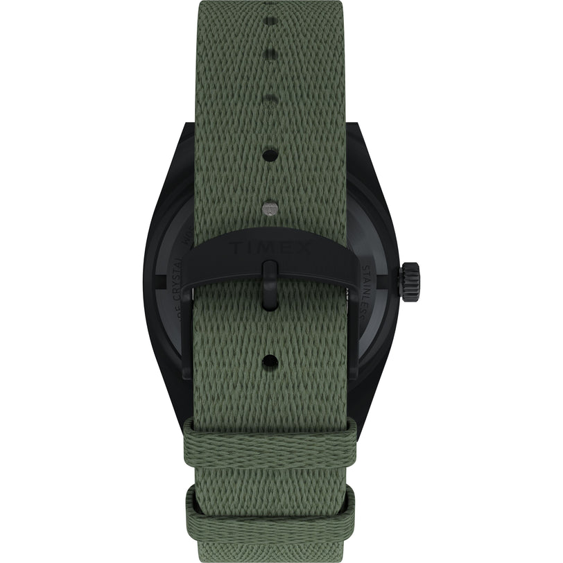 A close-up shows the back of the Timex Expedition® Capstone Automatic, a 39mm stainless steel watch with a textured green fabric strap and black metal buckle featuring the Timex logo.