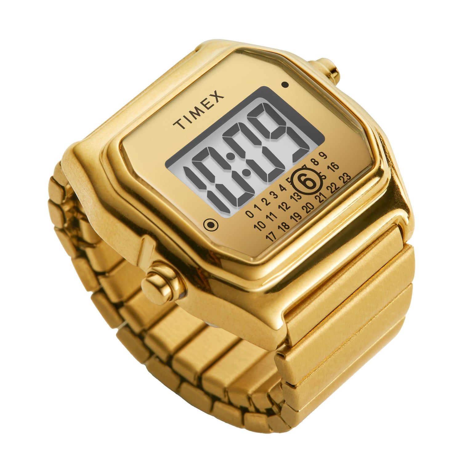 The Timex MM6 Gold Tone Digital Ring Watch features a rectangular digital face showing 10:09 with a calendar, set on a matching gold band—a classic design inspired by MM6 Maison Margiela collaborations.