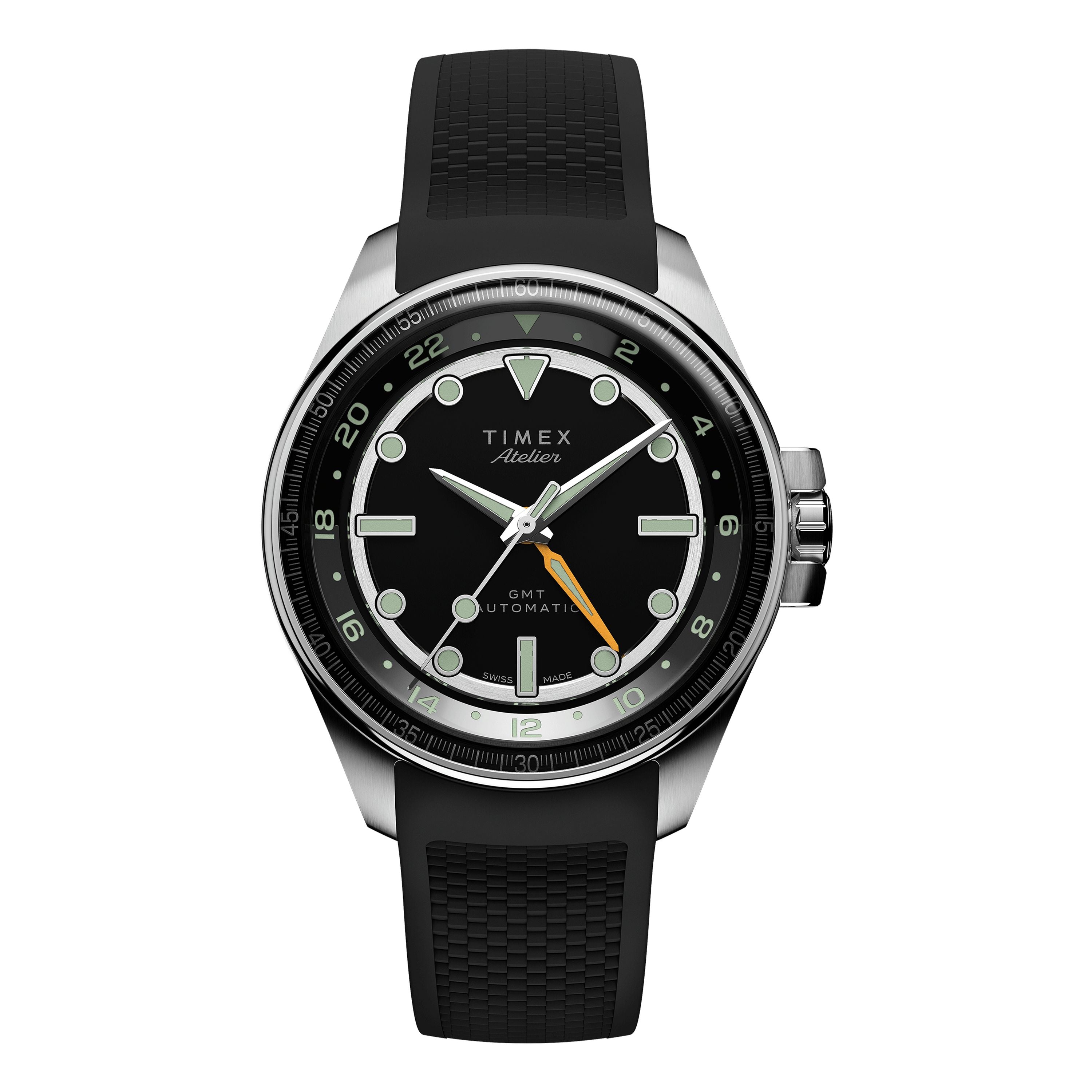 A Timex Atelier GMT24 M1a Swiss Made Automatic wristwatch with a black dial, silver hour markers, black bezel, orange GMT hand, and a black textured rubber strap. The watch face reads Timex Atelier GMT24.