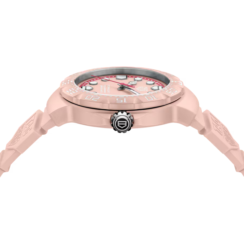Pink wristwatch with detailed design on a white background