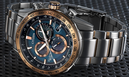 Silver and rose gold Citizen watch with blue face on a textured black background