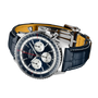 Luxury watch with blue face and leather strap on a white background