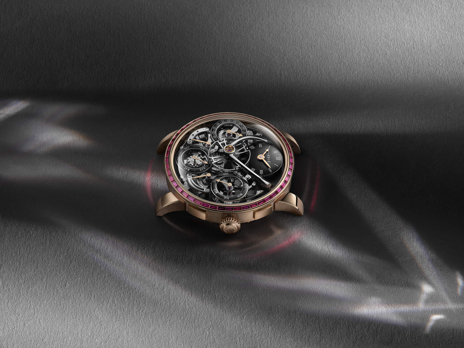 Luxury watch with intricate design on a dark fabric background