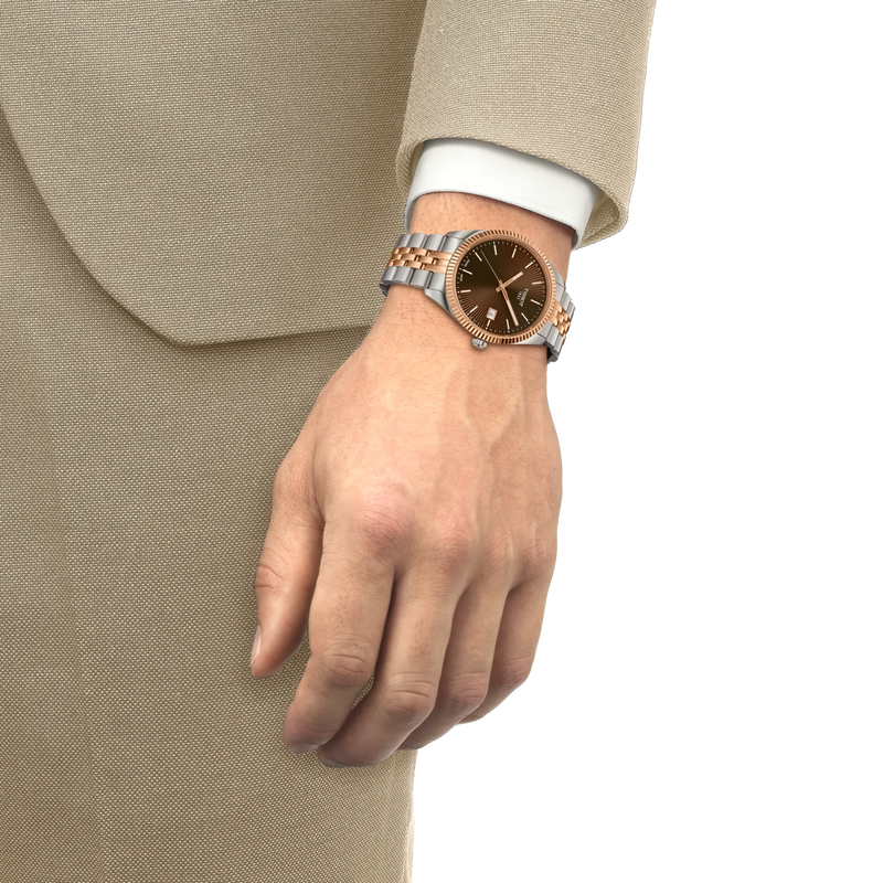 Hand wearing a watch with a beige suit on a white background
