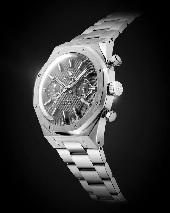 Stainless steel chronograph watch with grey dial, subsidiary dials, and matching bracelet on black background.