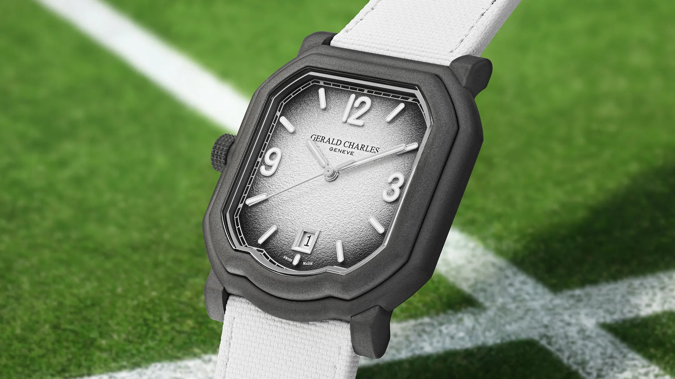 Watch with a black case and white strap on a grassy field background