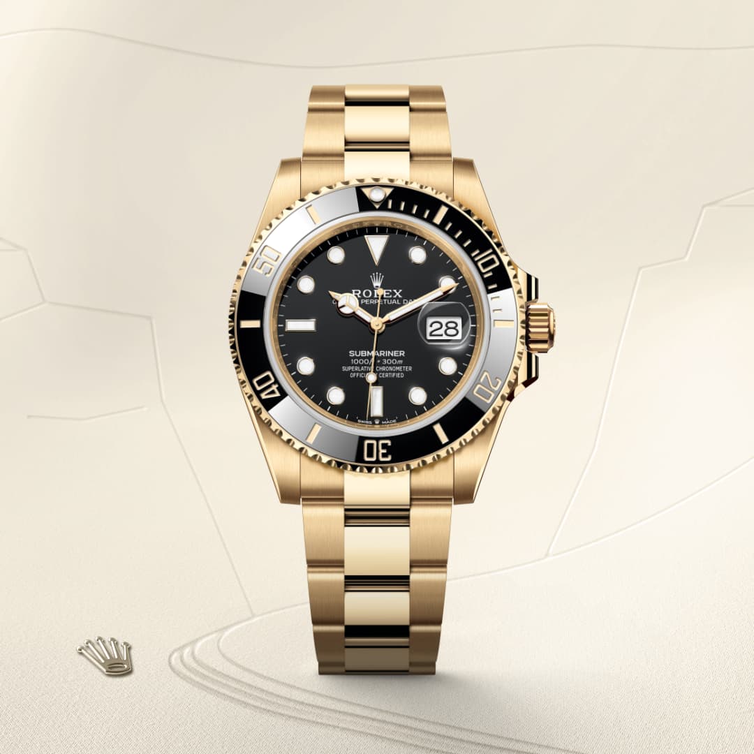 A gold Rolex Submariner watch with a black dial and date display, shown on a light beige background.