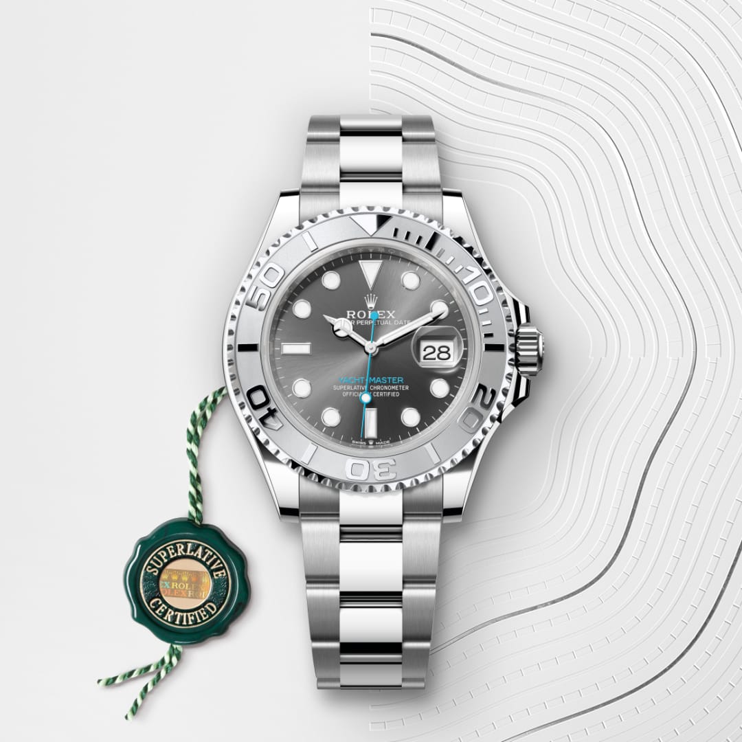 A silver Rolex Yacht-Master watch with a black dial and date display, next to a green Superlative Certified seal.