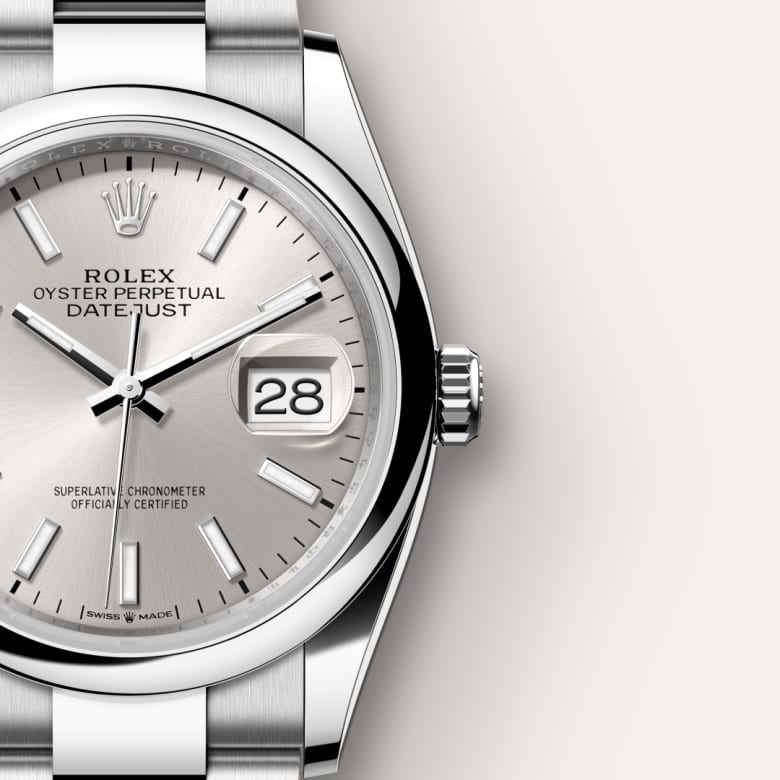 Close-up of a silver Rolex Oyster Perpetual Datejust watch showing the date as 28.