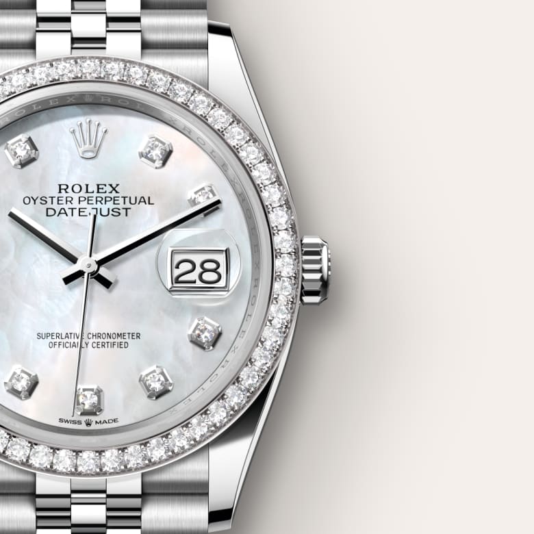 Close-up of a Rolex Datejust watch with a diamond bezel and diamond hour markers on a white mother-of-pearl dial.