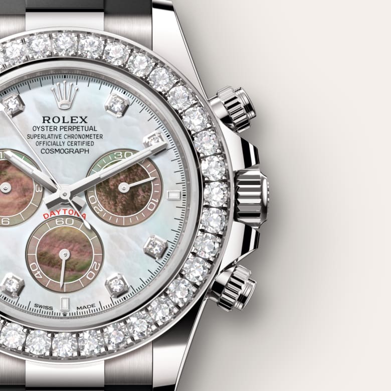Close-up of a luxury Rolex watch with a diamond bezel and white mother-of-pearl dial.