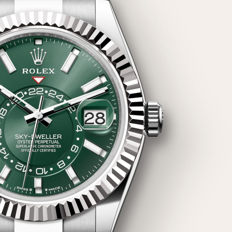 Close-up of a green Rolex Sky-Dweller watch face, showing the date and multiple time indicators.