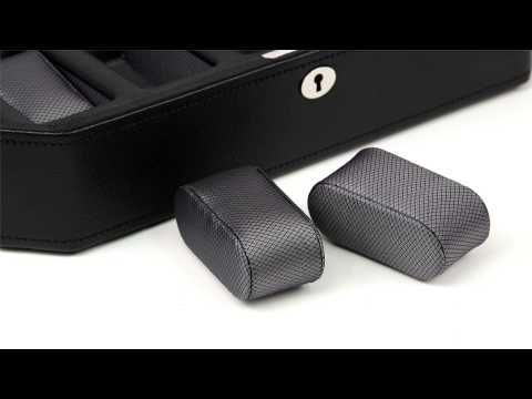 Black watch box with five cushioned compartments and keyhole lock.