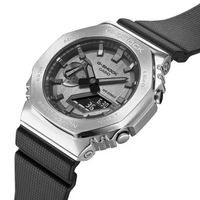 Stainless steel G-Shock watch with black fabric band, analog-digital dial, and square case.
