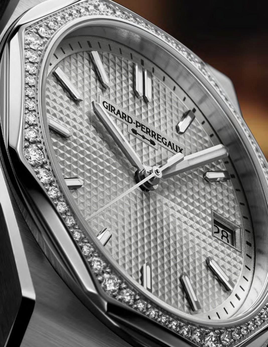 Closeup on diamond set octagonal bezel and silver dial