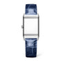 The Jaeger-LeCoultre Reverso Classic Monoface is a rectangular stainless steel watch with a plain face and textured blue leather strap, shown upright against a white background.