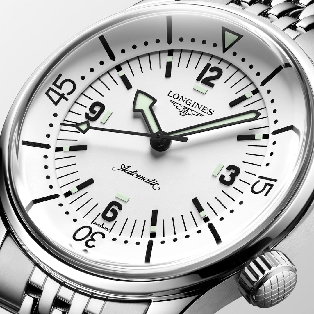 Close-up of the Longines Legend Diver automatic wristwatch featuring a white dial, black numerals, and a metal bracelet.