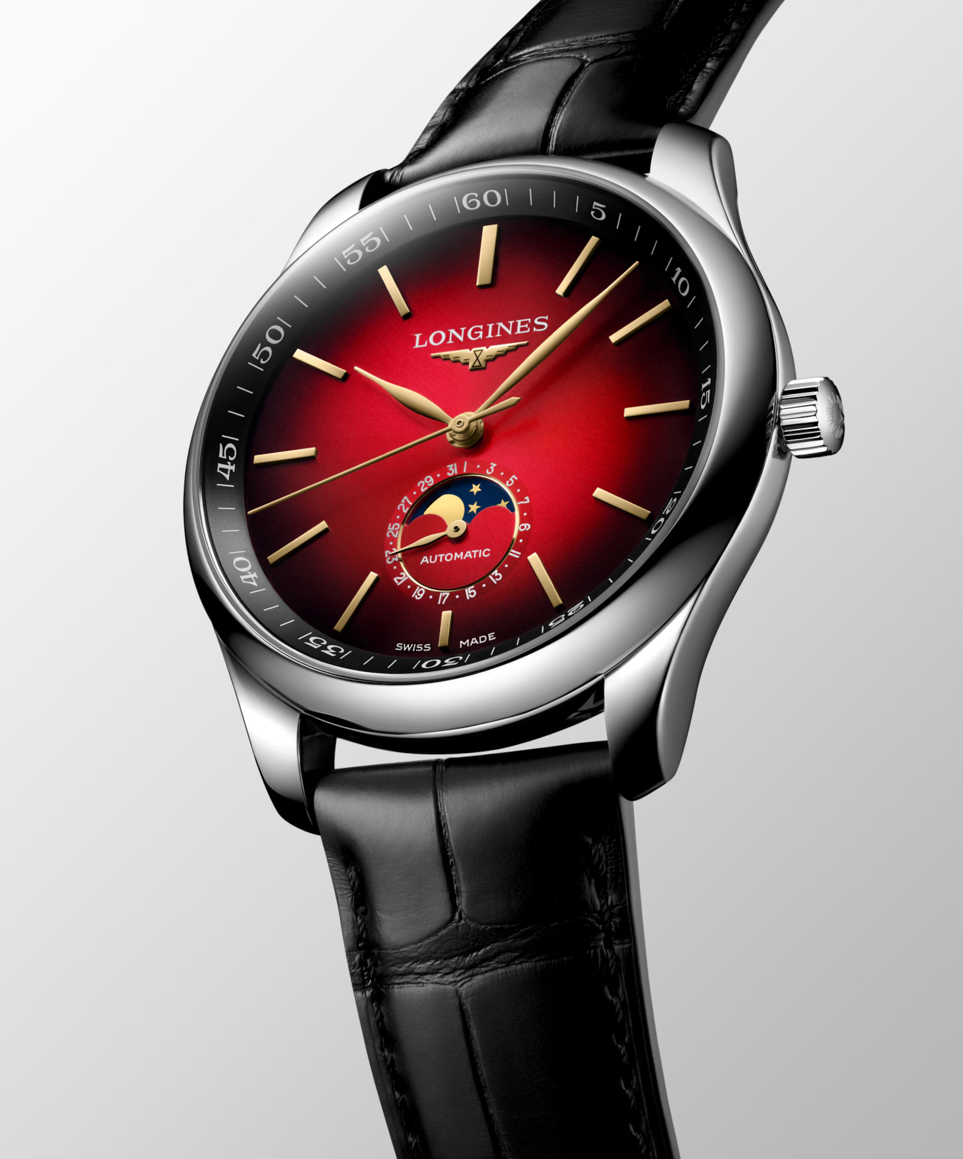 The Longines Master Collection Year of the Horse wristwatch features a red gradient dial, gold hour markers, moonphase subdial, and black leather strap—showcasing refined craftsmanship against a light backdrop.