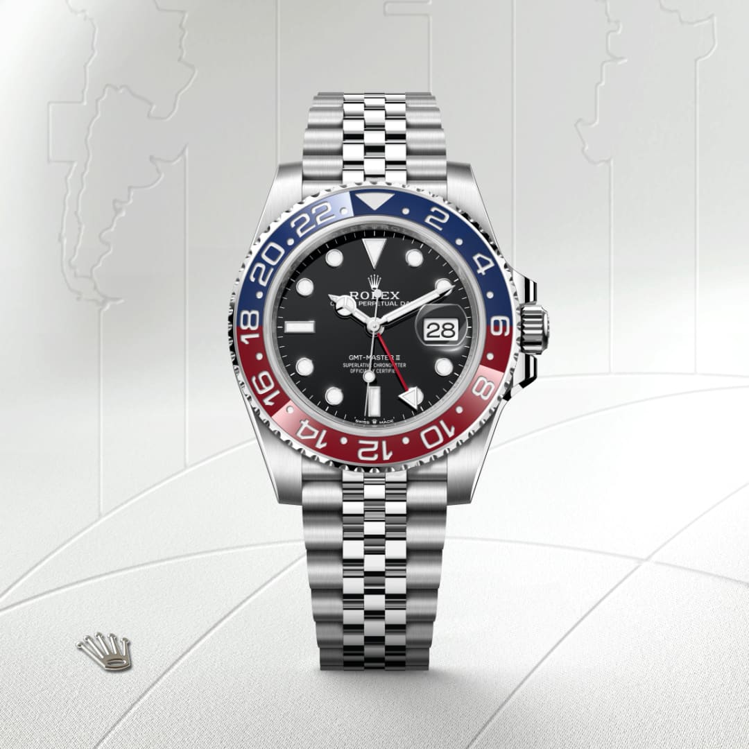 Rolex GMT-Master II watch with a black dial and red-blue bezel on a silver jubilee bracelet.