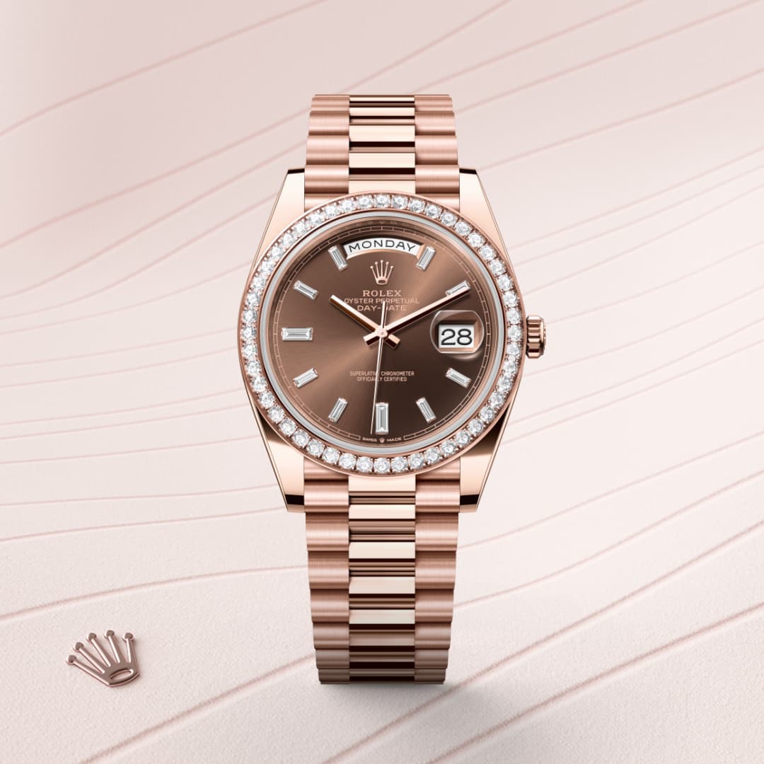 A rose gold Rolex watch with a diamond bezel and day-date display, set on a patterned pale background.