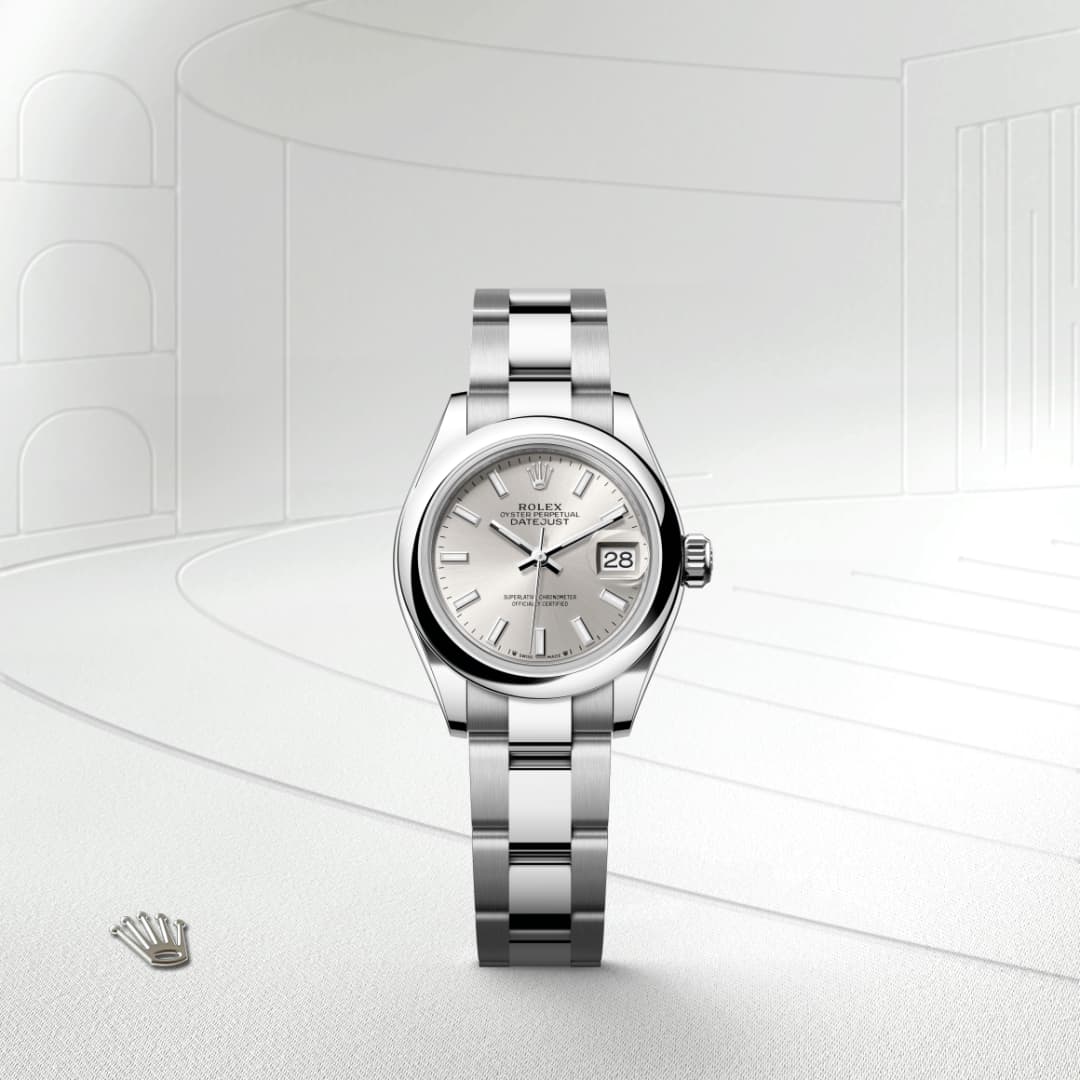 A silver Rolex Oyster Perpetual Datejust watch displayed on a light, minimalist background.