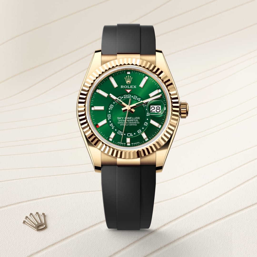 Gold Rolex watch with a green face and black strap displayed on a light patterned surface with a crown emblem nearby.