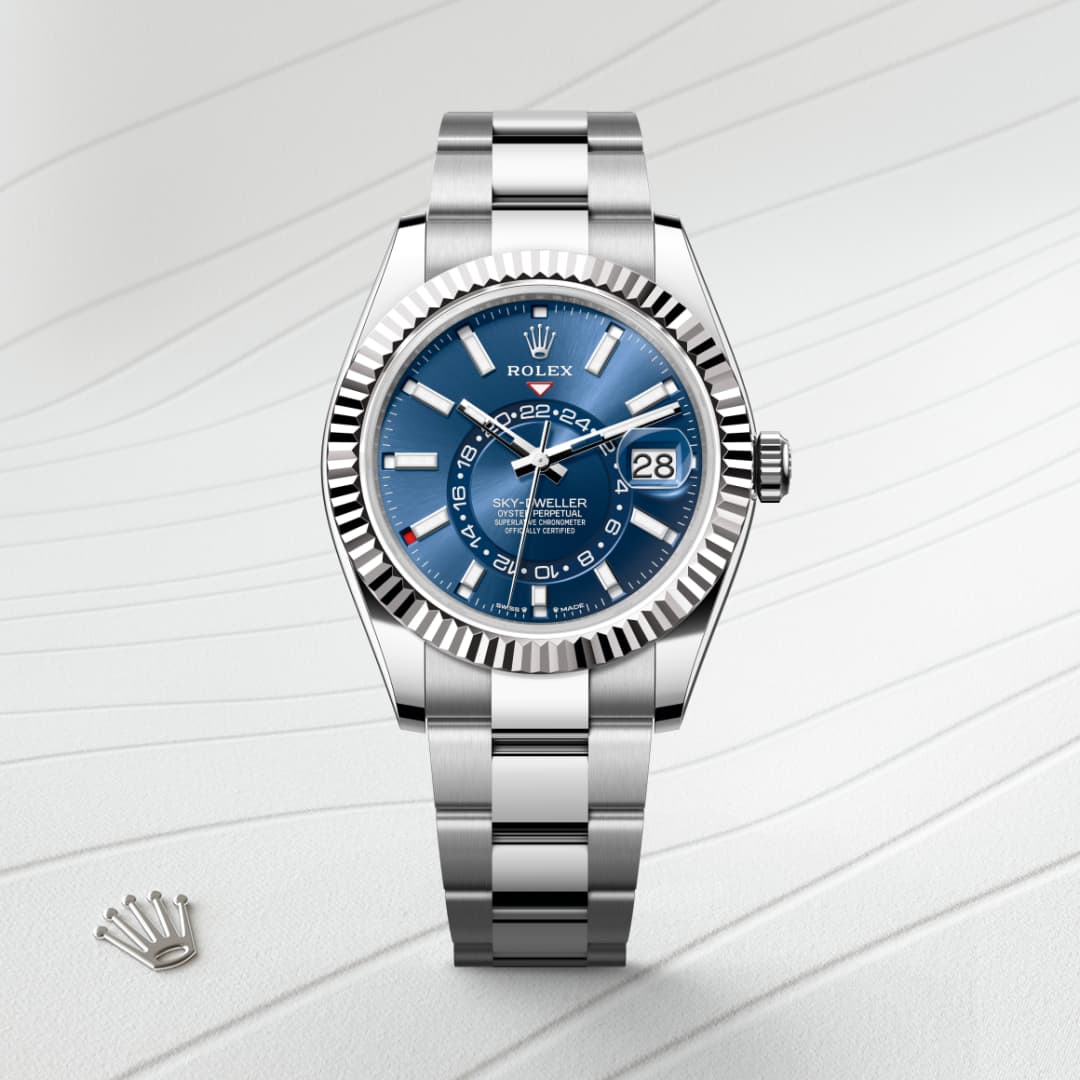 A silver Rolex Sky-Dweller watch with a blue dial on a textured white background.