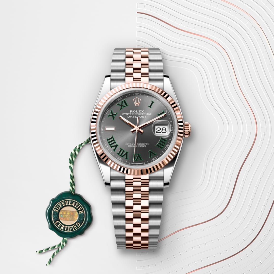 A Rolex Datejust watch with a silver and rose gold band, green Roman numerals, and a Superlative Certified tag.