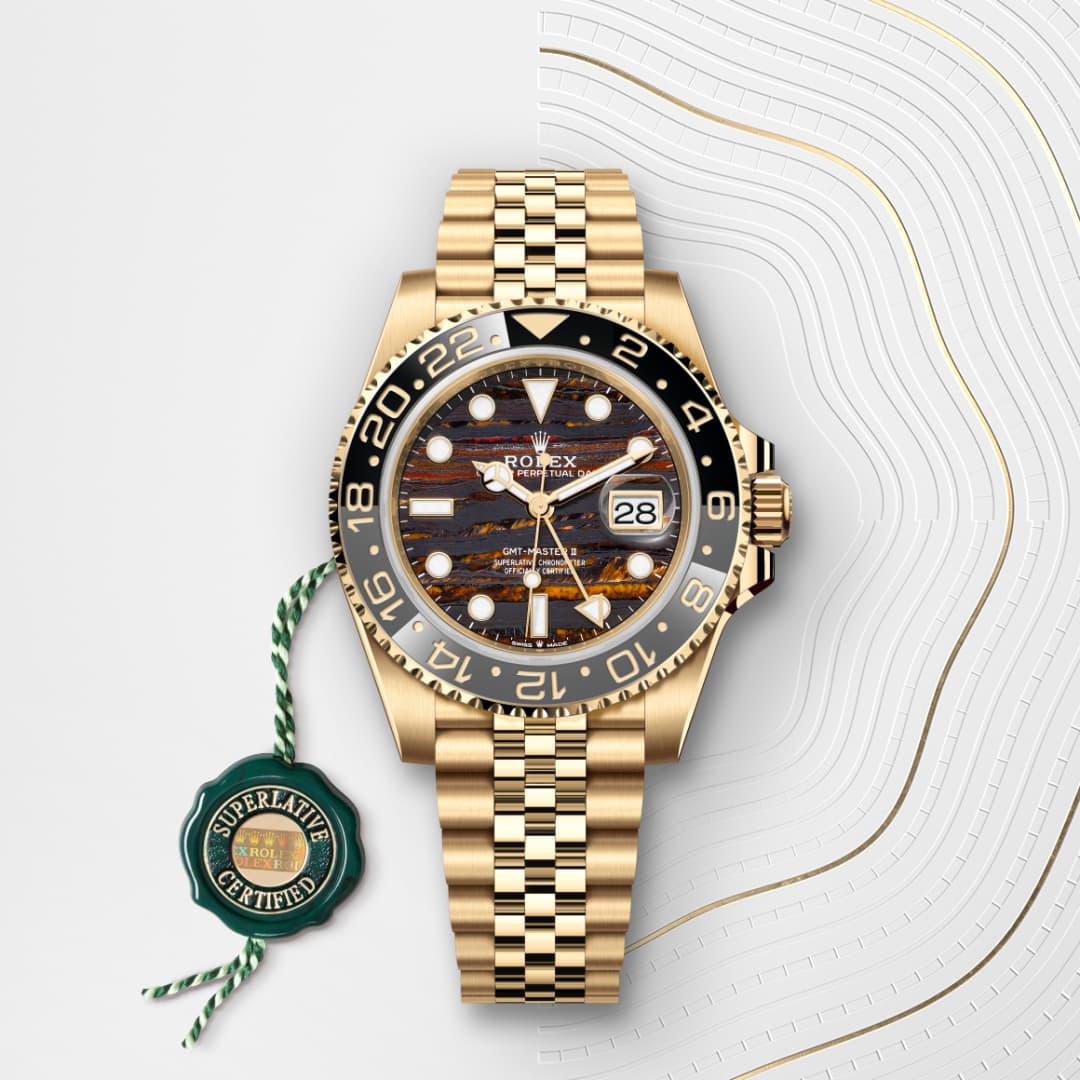 Gold Rolex watch with black and gold bezel, tiger-pattern dial, and Jubilee bracelet on a white textured background.