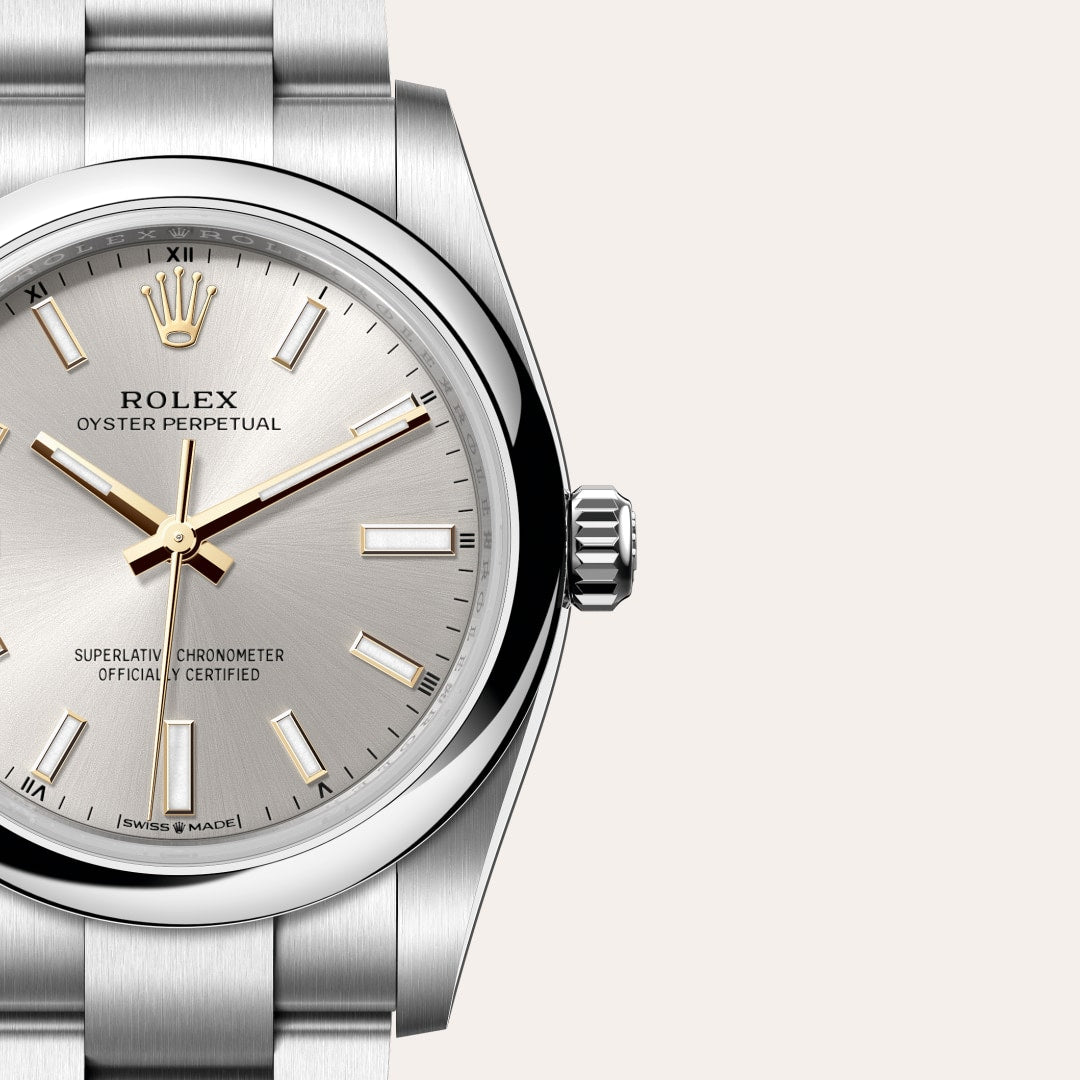 Close-up of a silver Rolex Oyster Perpetual watch with a stainless steel band and simple dial.