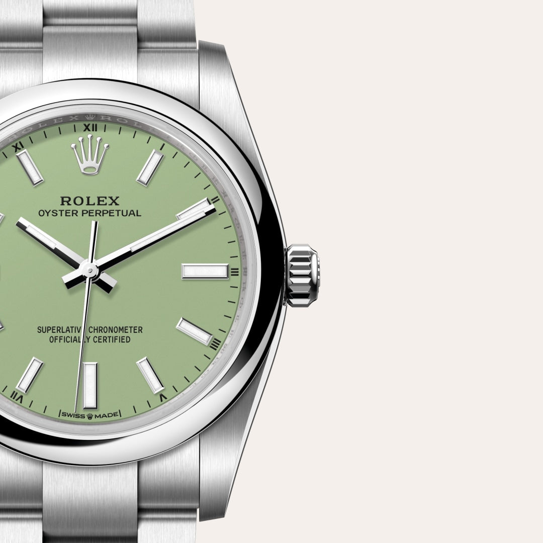 Close-up of a Rolex Oyster Perpetual watch with a light green dial and silver metal bracelet.