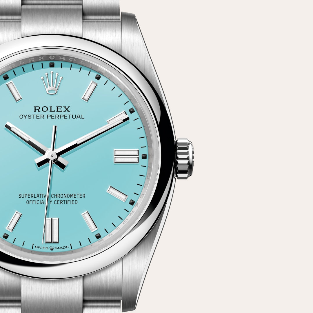Close-up of a Rolex Oyster Perpetual watch with a turquoise blue dial and stainless steel case.