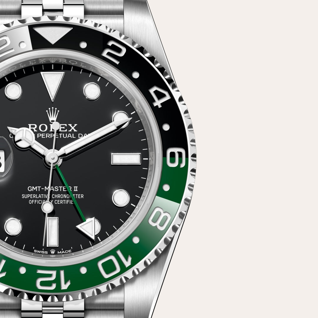 Close-up of a Rolex GMT-Master II watch with a black and green bezel and a black dial.