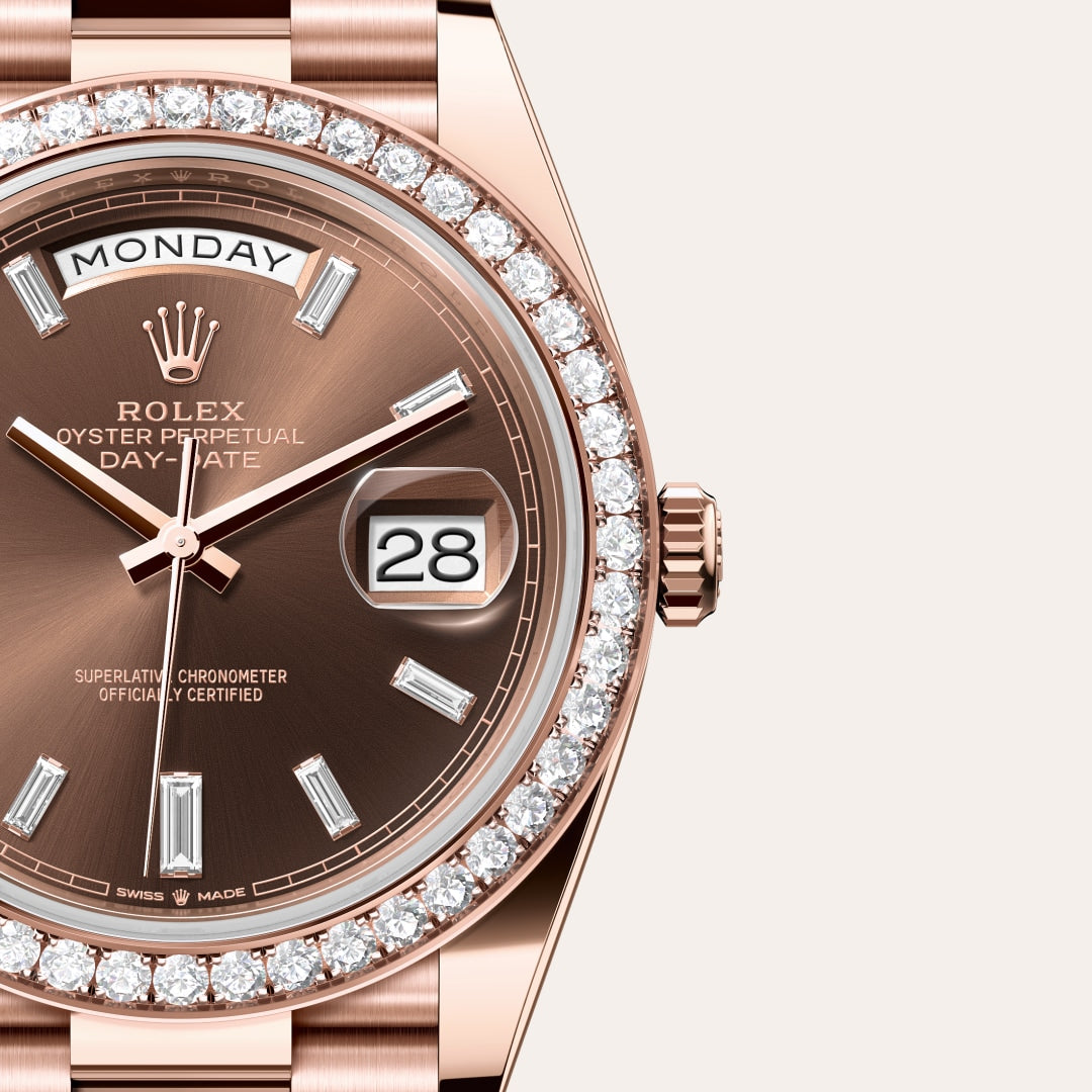 Close-up of a rose gold Rolex Day-Date watch with a diamond bezel, brown dial, and date display.