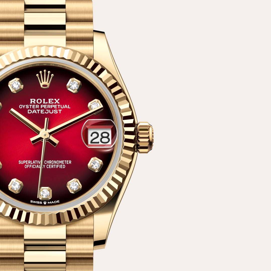 Gold Rolex Datejust watch with a red gradient dial, diamond hour markers, and the date showing “28”.