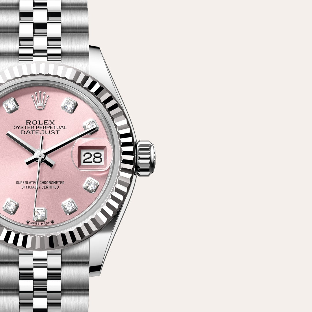 A Rolex Datejust watch with a pink dial, diamond hour markers, and a silver metal bracelet.