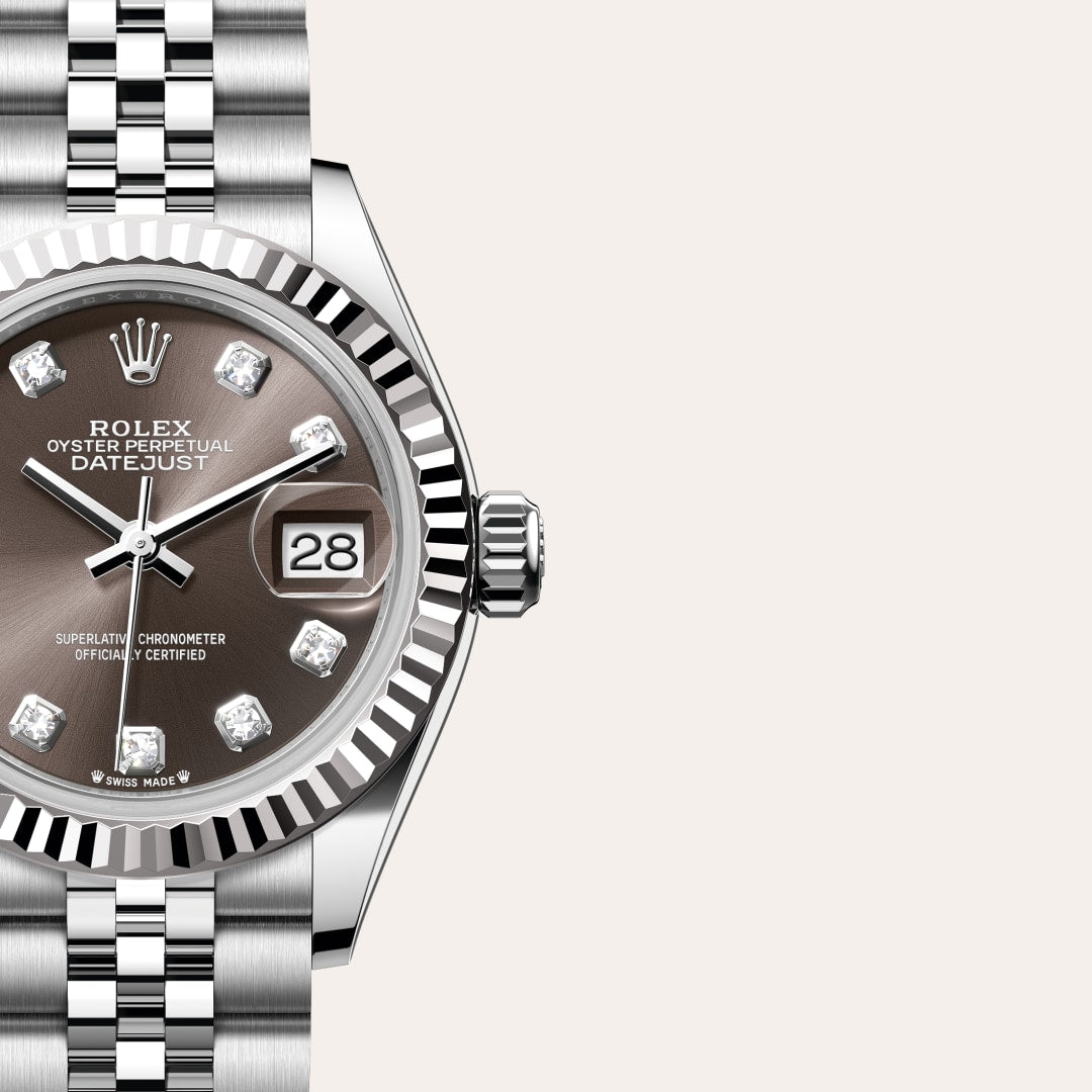 Close-up of a Rolex Datejust watch with a gray dial, diamond hour markers, and a silver jubilee bracelet.
