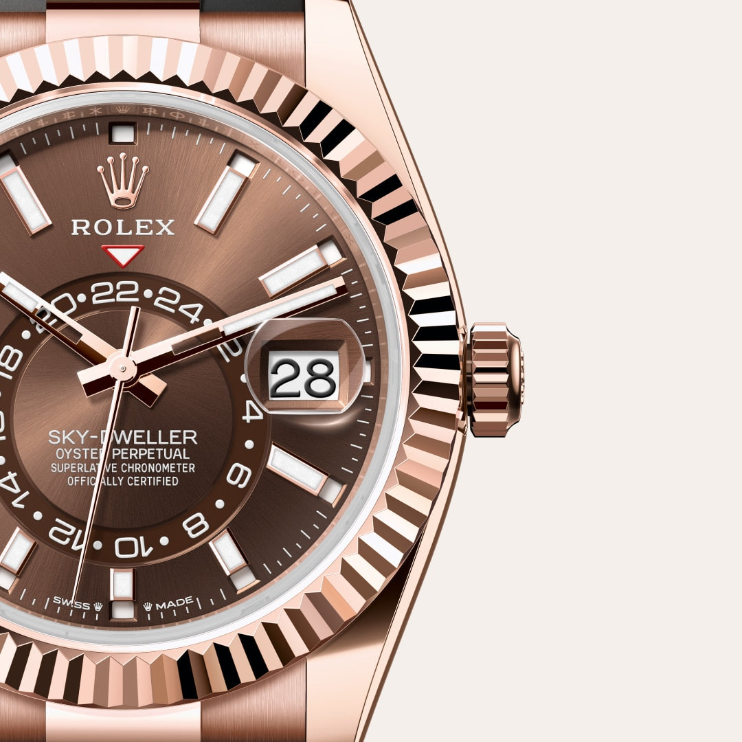 Close-up of a Rolex Sky-Dweller watch with a brown dial and rose gold case, showing the date and time.