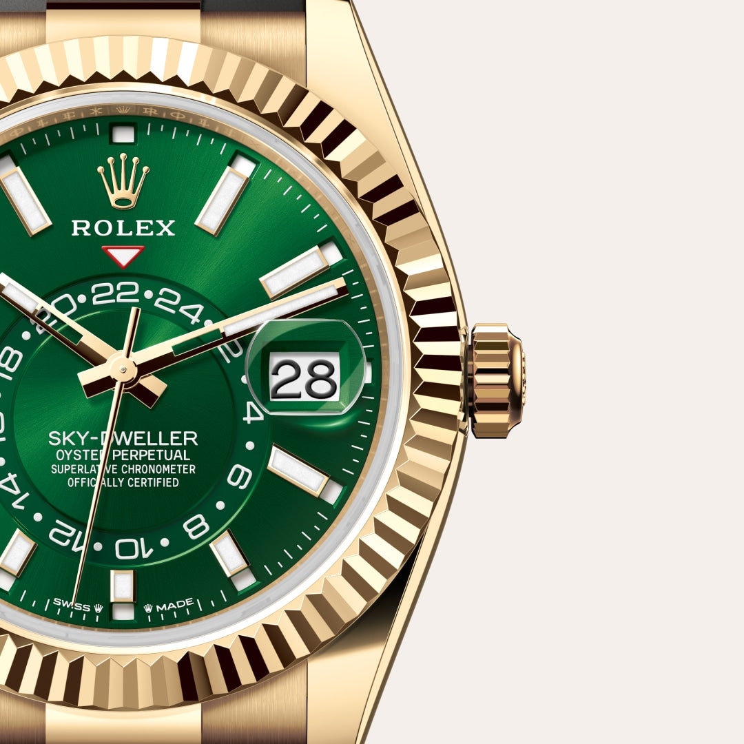 Close-up of a gold Rolex Sky-Dweller watch with a green dial and date window showing the 28th.
