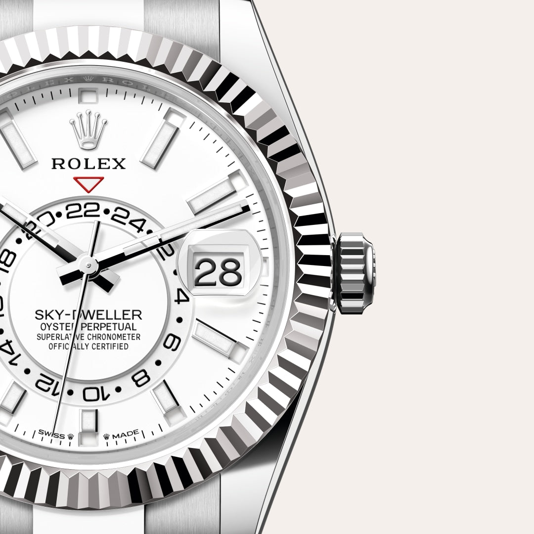 Close-up of a Rolex Sky-Dweller watch with a white dial, date display, and fluted bezel.